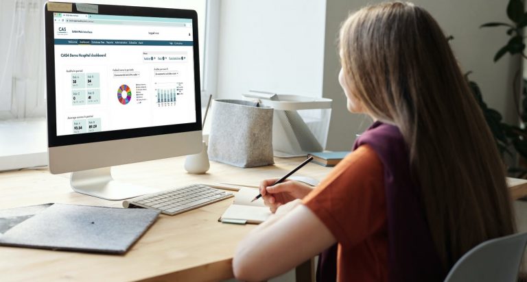 Woman at desk with CAS4 software on screen